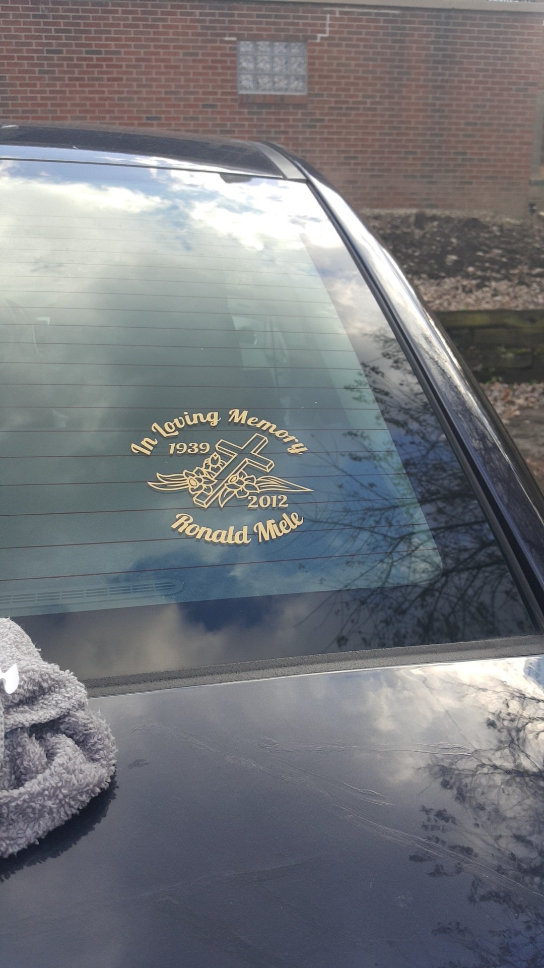 Katelyn's photograph of their In Loving Memory Cross with Flowers Sticker