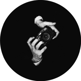 A Man Photographer Holding A Camera In Black Sticker