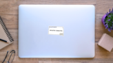 A South Dakota State Outline With The Motto Sticker on a Laptop (New) example