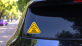 Adorable Baby on Board Triangle Sticker on a Rear Car Window (New) example