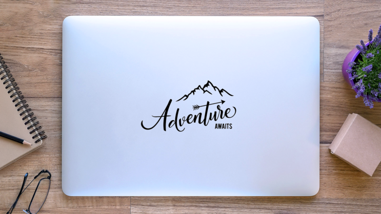 Adventure Awaits Typography Mountain Sticker on a Laptop (New) example