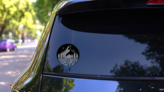 Adventure Is Waiting Circle Sticker on a Rear Car Window (New) example