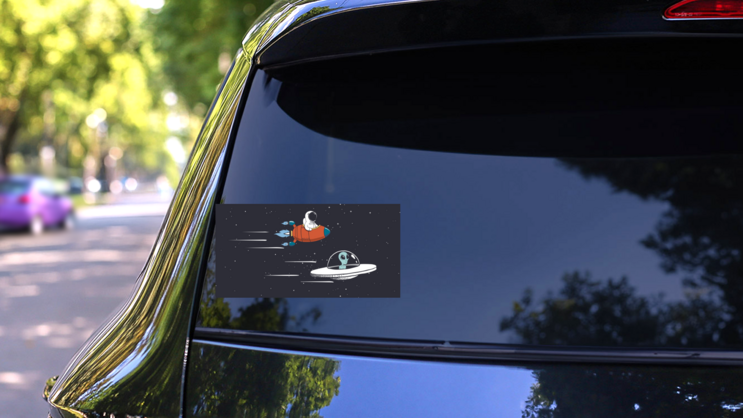 Alien and Human Spaceship Race Sticker on a Rear Car Window (New) example