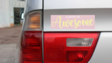Always Be Awesome Bumper Sticker on a Gold Car Rear Bumper example