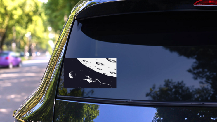 Astronaut Flying Near The Moon Sticker on a Rear Car Window (New) example