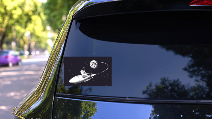 Astronaut Surfing on a Spaceship Sticker on a Rear Car Window (New) example