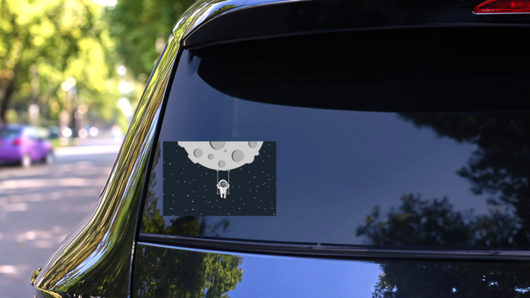 Astronaut Swinging On The Moon Sticker on a Rear Car Window (New) example