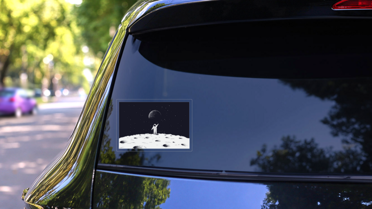 Astronaut Waving On Moon Sticker on a Rear Car Window (New) example