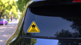 Baby On Board Sign With Child Pacifier Sticker on a Rear Car Window (New) example