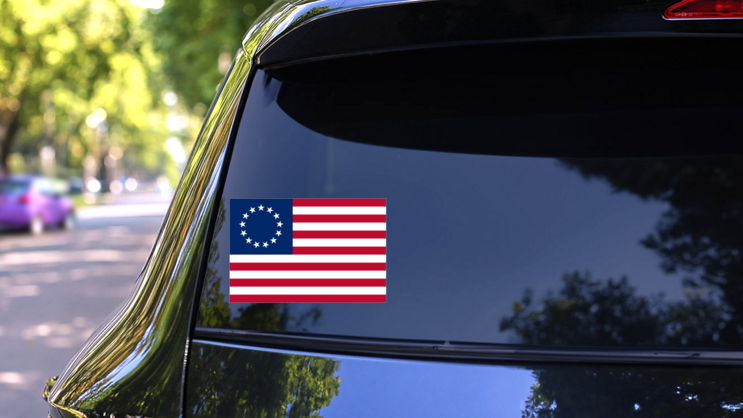 Betsy Ross Flag Of The United States Sticker on a Rear Car Window (New) example