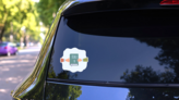 Bible Between Two Hands Illustration Sticker on a Rear Car Window (New) example