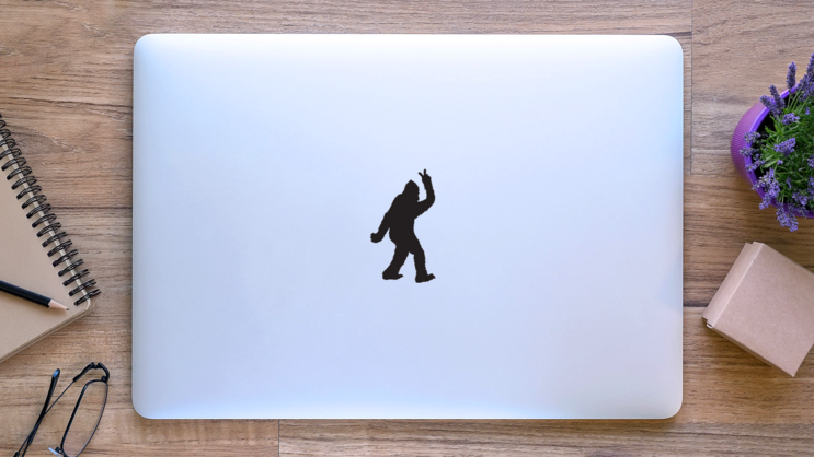 Bigfoot Throwing Peace Sign Sticker on a Laptop (New) example