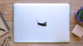 Black Silhouette Of Huge Grasshopper Sticker  on a Laptop (New) example