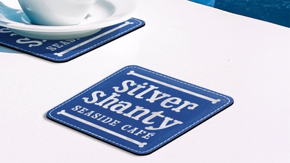 Blue leather engraved coaster with cafe logo