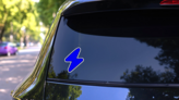 Blue Lightning Bolt Icon Sticker on a Rear Car Window (New) example