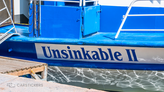 A decal on a boat with the name Unsinkable II.