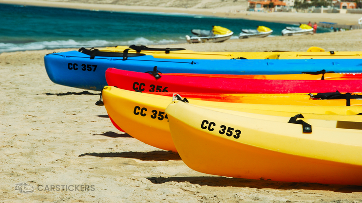 Registration decals on the side of rental kayaks.