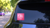 Breast Cancer Awareness Background With Pink Ribbon Sticker on a Rear Car Window (New) example
