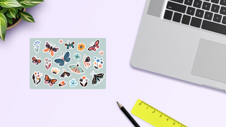 Butterfly And Flowers Sticker Sheet on a Desk (New) example
