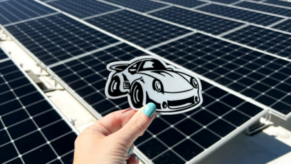 Car Stickers Logo Sticker in Hand with Solar Panels in the Background