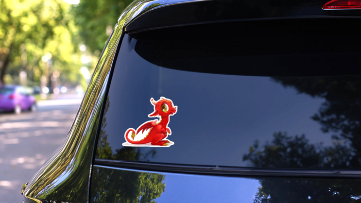 Cartoon Little Red Dragon Sticker on a Rear Car Window (New) example