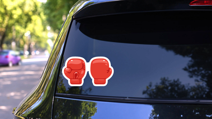 Cartoon Red Boxing Glove Icon Sticker on a Rear Car Window (New) example