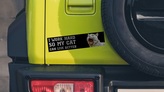 Cat bumper sticker applied to back of Jeep