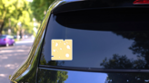 Cheese Slice With Holes In Shape Of A Square Sticker on a Rear Car Window (New) example