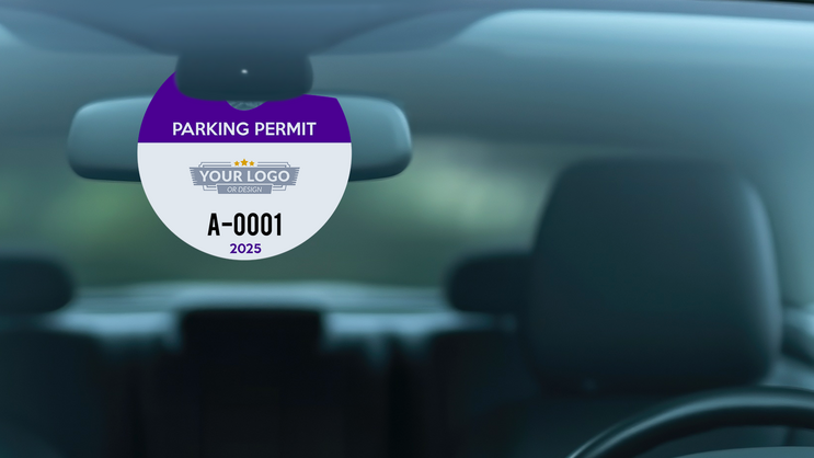Round parking permit hang tag in windshield of parked car.