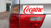 Cocaine Bumper Sticker on a Gold Car Rear Bumper example