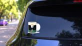 Coffee Mug With National Costume Of Ireland Sticker on a Rear Car Window (New) example