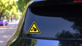 Crushing Gear Sign Sticker on a Rear Car Window (New) example