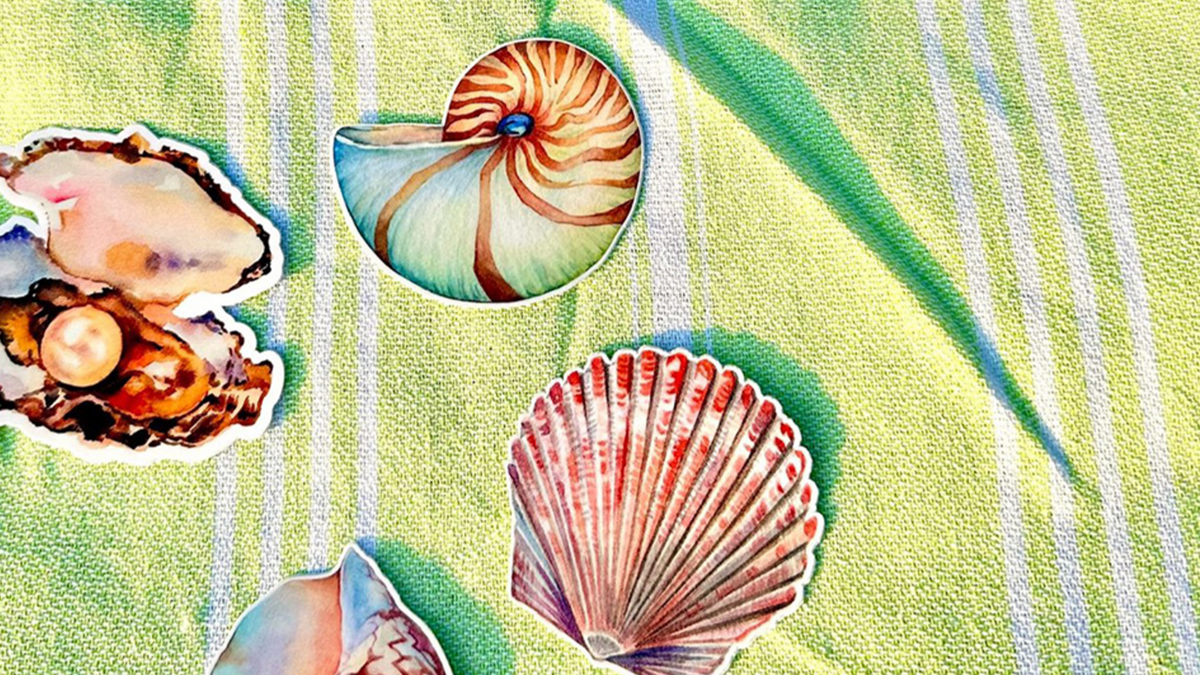 Seashell Stickers on a Towel on the Beach to Promote Summer Stickers