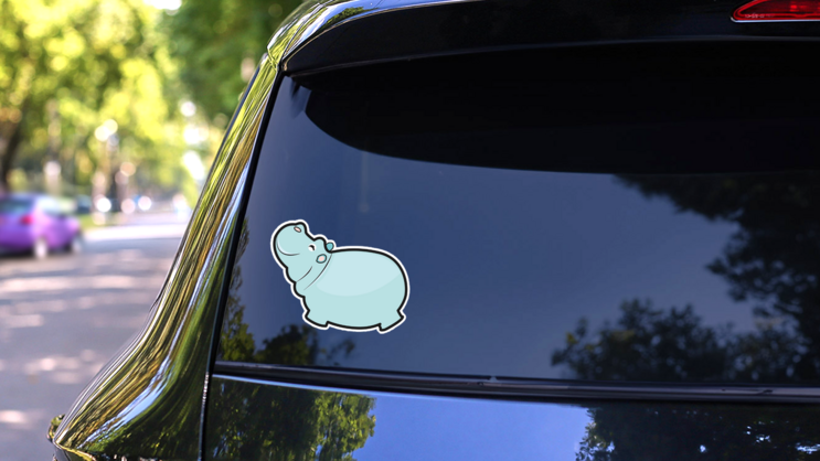 Cute Cartoon Hippo In Blue Sticker on a Rear Car Window (New) example