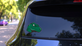 Cute Raptor Mascot Sticker on a Rear Car Window (New) example