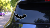 Dark Silhouette Of Bat With Open Wings Sticker on a Rear Car Window (New) example