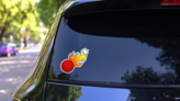 Dodgeball With Flames Cartoon Sticker on a Rear Car Window (New) example