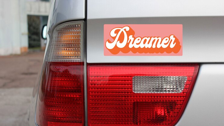 Dreamer Retro Bumper Sticker on a Gold Car Rear Bumper example