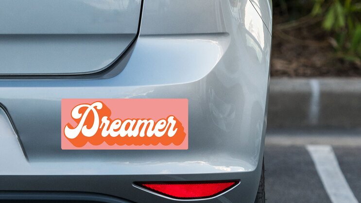 Dreamer Retro Bumper Sticker on a Grey Car Bumper example