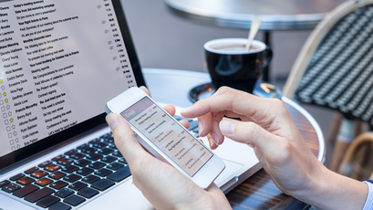 Scrolling through email on phone while email is up on the laptop