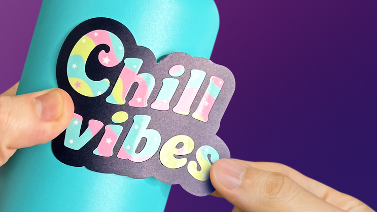 An embossed sticker being applied to a water bottle.