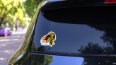 Fisted Hand Holding Zimbabwean Flag Sticker on a Rear Car Window (New) example