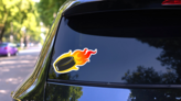 Flaming Hockey Puck Sticker on a Rear Car Window (New) example
