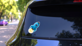 Flying Blue Rocket Sticker on a Rear Car Window (New) example
