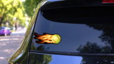 Flying Softball On Fire Sticker on a Rear Car Window (New) example