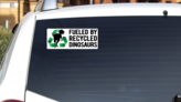Fueled By Dinosaurs Bumper Sticker on a White Car Rear Window example