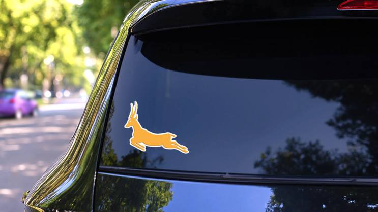 Gold Antelope Jumping Sticker on a Rear Car Window (New) example