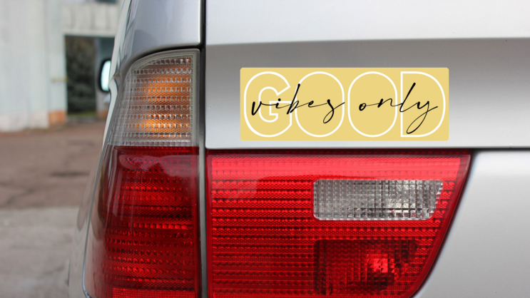 Good Vibes Only Bumper Sticker on a Gold Car Rear Bumper example
