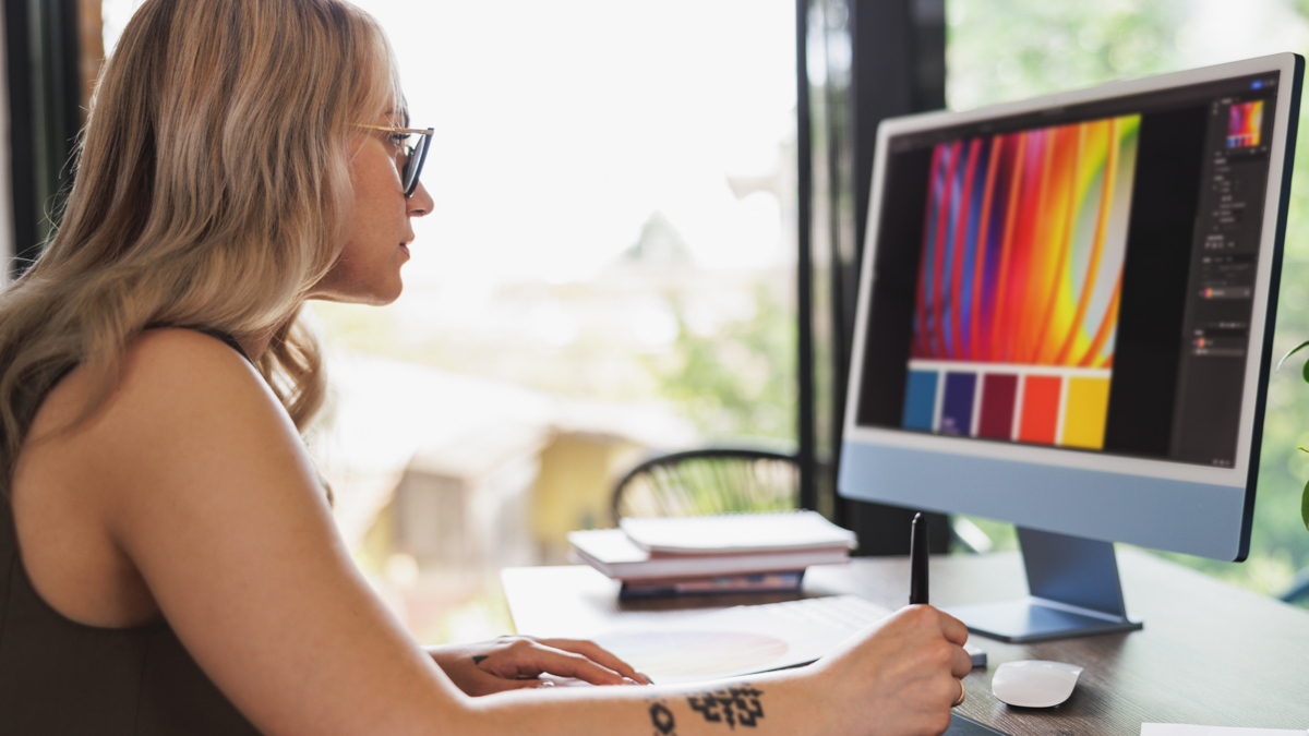 Graphic Designer Working at a Computer to Vectorize a Sticker Design