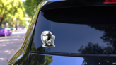 Grayscale Soccer Player Kicking Ball Sticker on a Rear Car Window (New) example